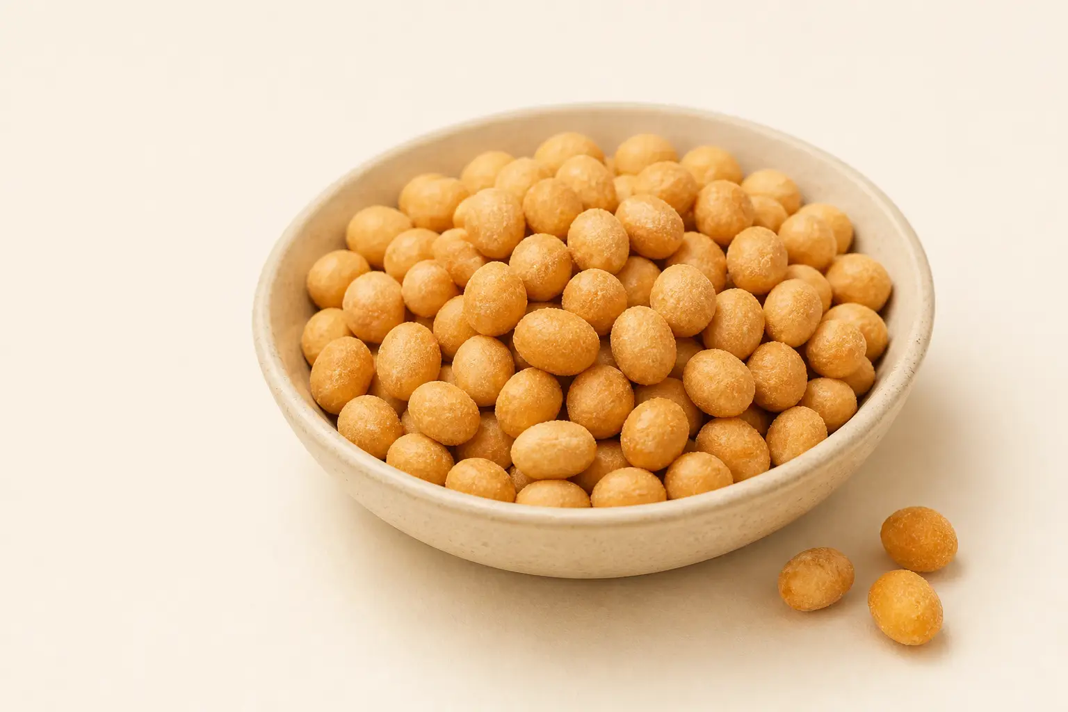 Golden coated peanuts in a ceramic bowl